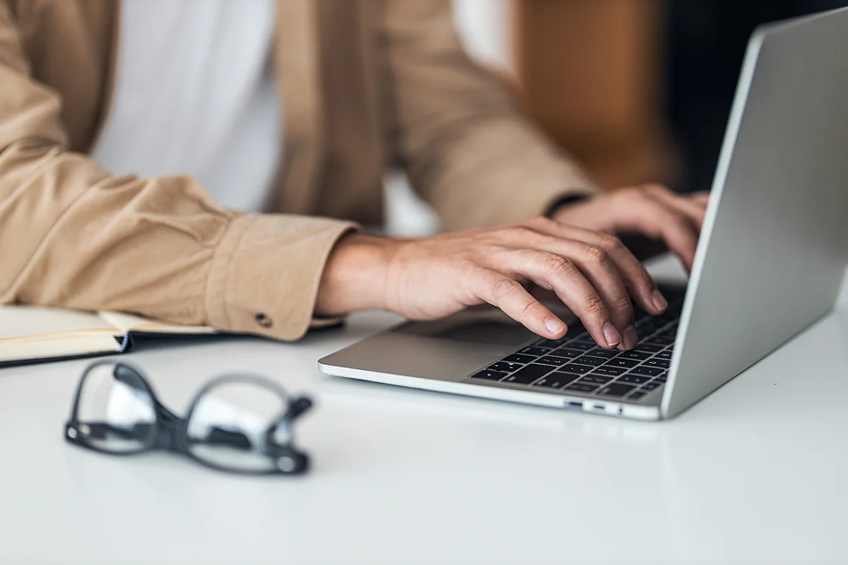 person types on laptop