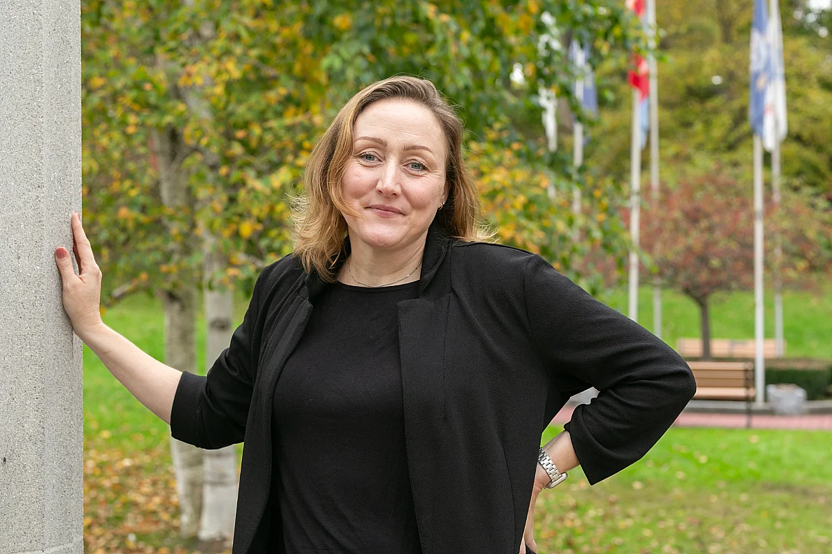 student poses for photo in the park