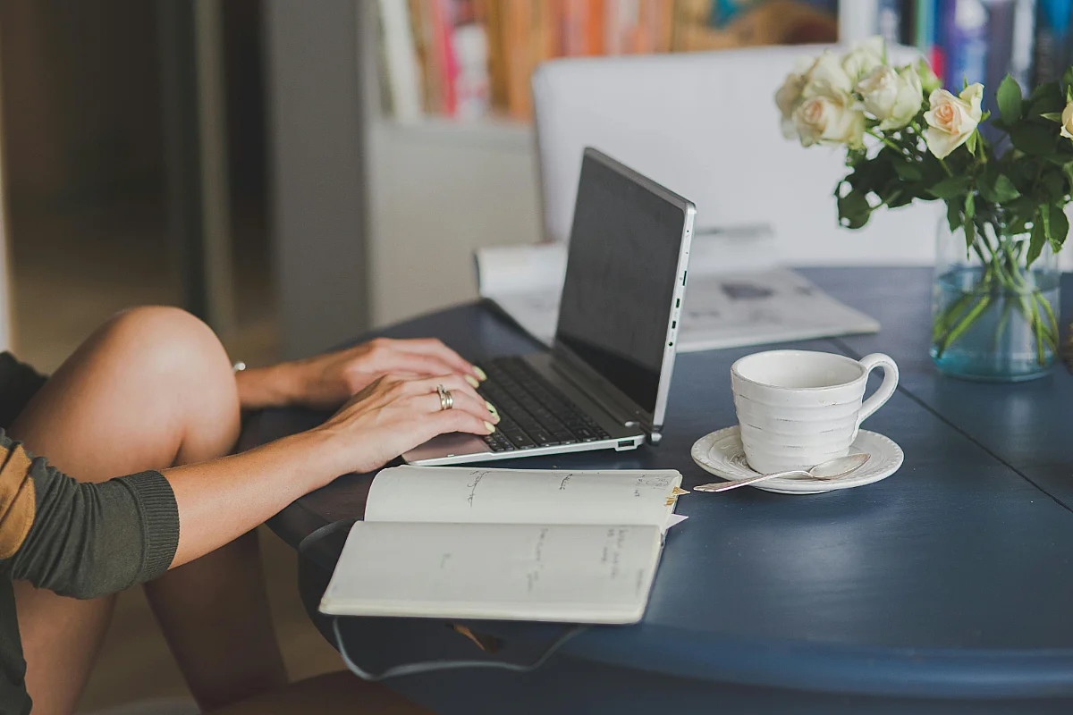 cropped photo of somebody using their laptop in their home