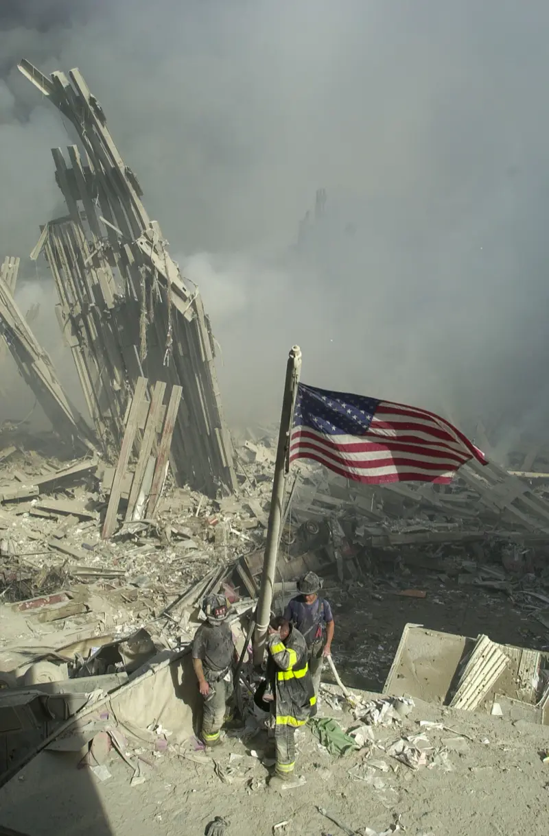 Ricky Flores' photo of&nbsp;exhausted firefighters hoisting an American flag in the ruins.&nbsp;