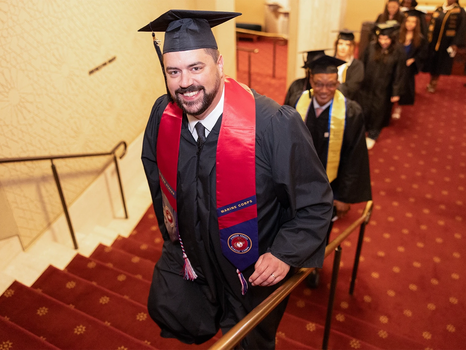 Student climbing the stairs before walking at graduation