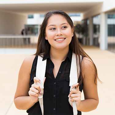 young Asian female with a bookbag on a campus