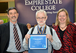 Vice President Paul Tucci and Acting President Meg Benke present Chuck Crawford, center, with the Chancellor’s Award for Excellence in Classified Service.