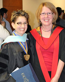 Associate Professor Julie Gedro smiles as she stands to the left of Dean Nikki Shrimpton at the 2014 Syracuse commencement exercise. Gedro was presented with a medallion and certificate in recognition of her being selected as a 2014 Chancellor’s Award for Excellence in in Scholarship and Creative Activities. Photo/Michael J. Okoniewski