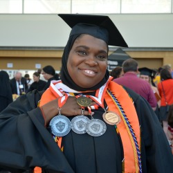 Layla Abdullah-Poulos displays her medallions and her Dean's Medal for her outstanding academic performance as a graduate student. Photo/Empire State College
