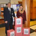 Executive Vice President for Administration Joseph L. Garcia, a retired lieutenant colonel and 28-year veteran of the U.S. Air Force, stands with Librarian Sara Hull in the lobby of 2 Union Ave., Saratoga Springs, N.Y., as cards for the Holidays for Heroes program were collected.